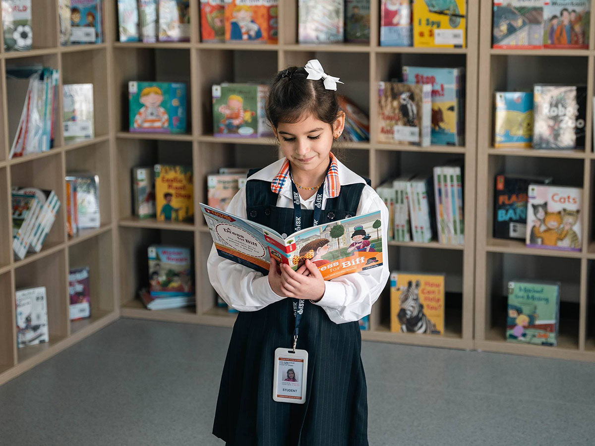 ISK student reading a book in the library